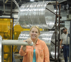 The new “lean initiative” is already producing significant improvements in efficiency and productivity, said Telescope Casual Furniture CEO Kathy Juckett. Behind her are table rims that have been bent into circles and are waiting for the next step in production. 