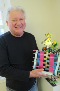 John Strong, director of the Lake George Arts Project, with hand-“enhanced” trophies to be awarded at this Saturday’s Black Velvet Art Party. Chronicle photos/Cathy DeDe