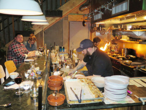 The kitchen at Peck’s Arcade is in full view. You can sit, eat and watch the chefs at work. That’s chef Nick Ruscitto in the baseball cap. Chronicle photos/Mark Frost
