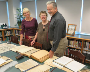 Kit Cornell (center), donor of the Wing family archive, a small portion seen here, flanked by Teresa Ronning, director of the SUNY Adirondack Library in Queensbury, and Paul McCarty, executive director of the Fort Edward Historical Association and Old Fort House Museum. Ms. Cornell worked through Mr. McCarty, who recommended the library’s Hill Collection as best repository for the documents that go back nearly 300 years. Chronicle photo/Mark Frost