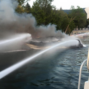 Three fireboats and firemen with hoses in the water helped put out the boat fire that followed an explosion in Lake George’s Kattskill Bay. Photo by Lake George Fire Chief Jason Berry