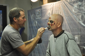 Make-up artist Phil Singer, in the process of transforming Jason Irwin.