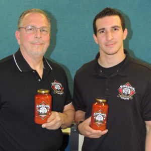 Joe Soprano and his son Tony display  jars of Soprano’s marinara sauce now available at the Glens Falls Food Co-Op, Bean’s Country Store, Bella’s Deli and Jacobs & Toney. Chronicle photo/Gordon Woodworth