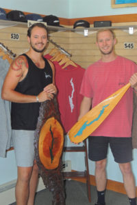 Domenick Pfau, left, and Matt Peterson, in their “Local” store in Bolton Landing with some of their  merchandise featuring a silhouette of Lake George. Chronicle photo/Gordon Woodworth