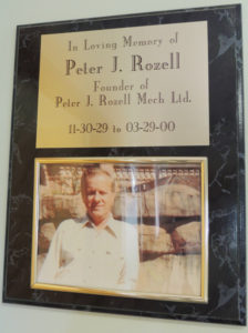 This plaque hangs in the main hallway of Rozell Industries’ offices, honoring Peter J. Rozell, the founder of the company. When he retired in 1992, there were eight employees. Now there are 200.