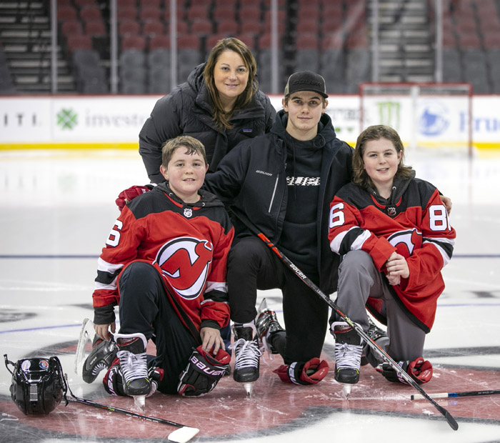 New Jersey Devils players, including Jack Hughes, right, wear